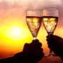 Two wine glasses clinking with a sunset background  