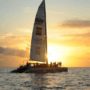 A lambada boat sailing with a sunset background