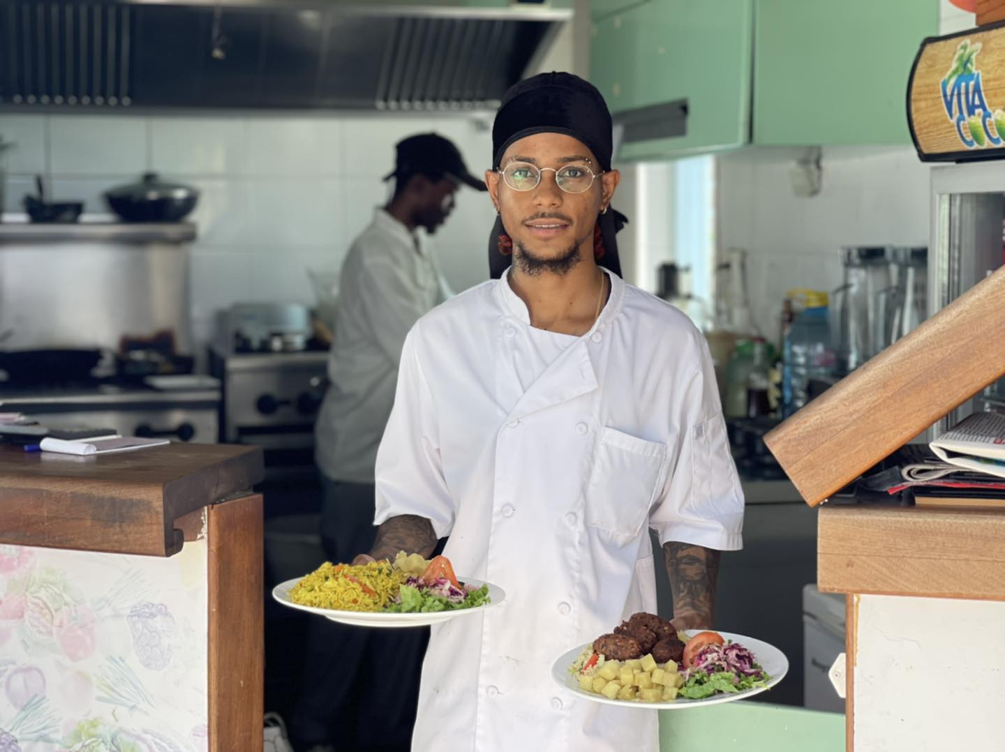 Chef at Irie Gardens with 2 plates in his hands