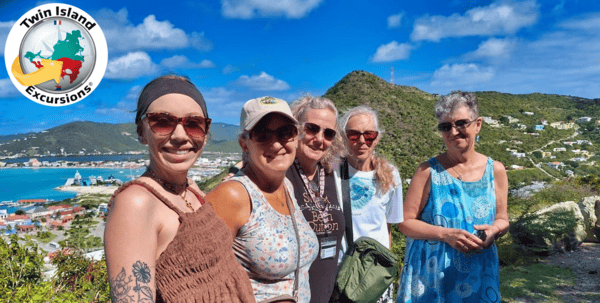 five people making a picture at Cole Bay Hill with Twin Island Excursions