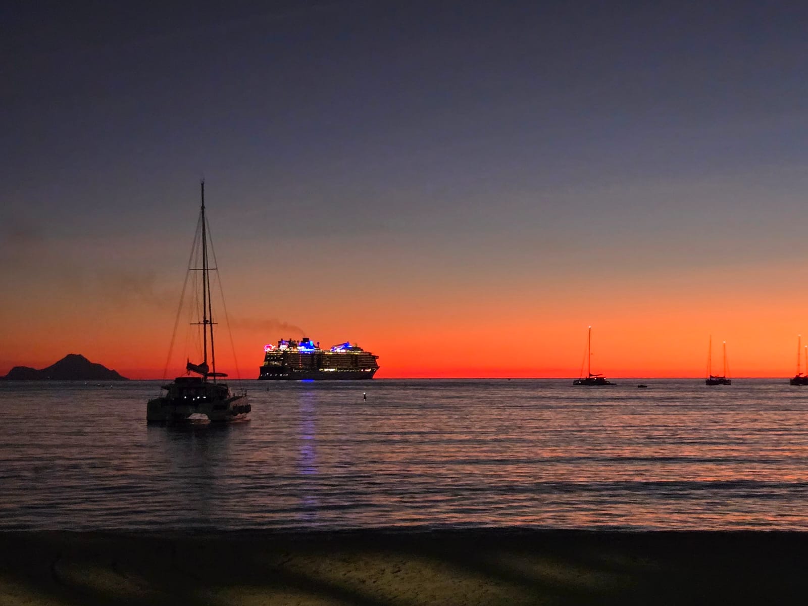 boats in the sea at sunset