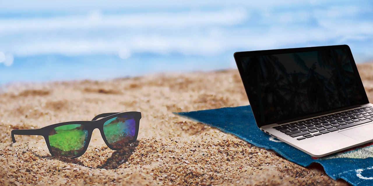 laptop and sunglasses at the beach